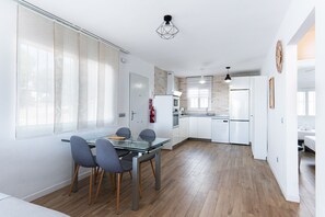 A modern kitchen with white cabinets, a built-in oven, and a dishwasher.
