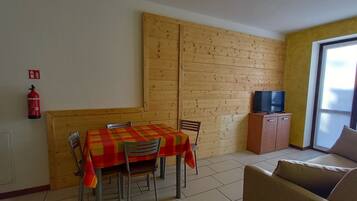 Standard Apartment | Living area | 28-inch flat-screen TV with digital channels, TV