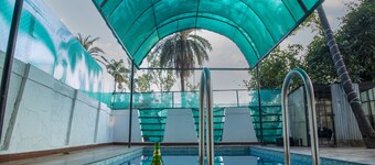 Your private oasis awaits - a 4 BHK villa with a pool near the city."