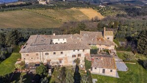 A large stone building with multiple rooms, surrounded by lush greenery and fields. - Il Convento by Interhome (Montefiridolfi)