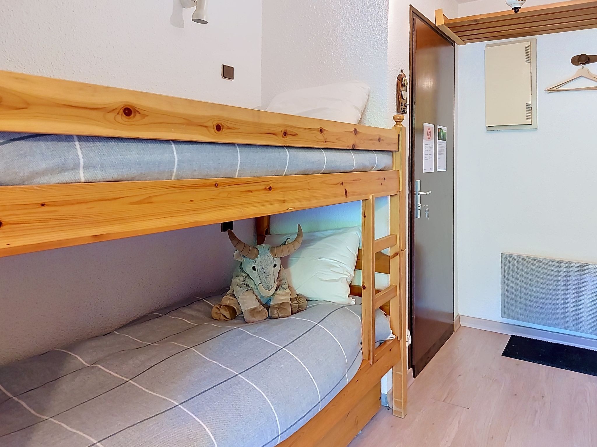 A bunk bed with a plush toy on the lower bunk.
