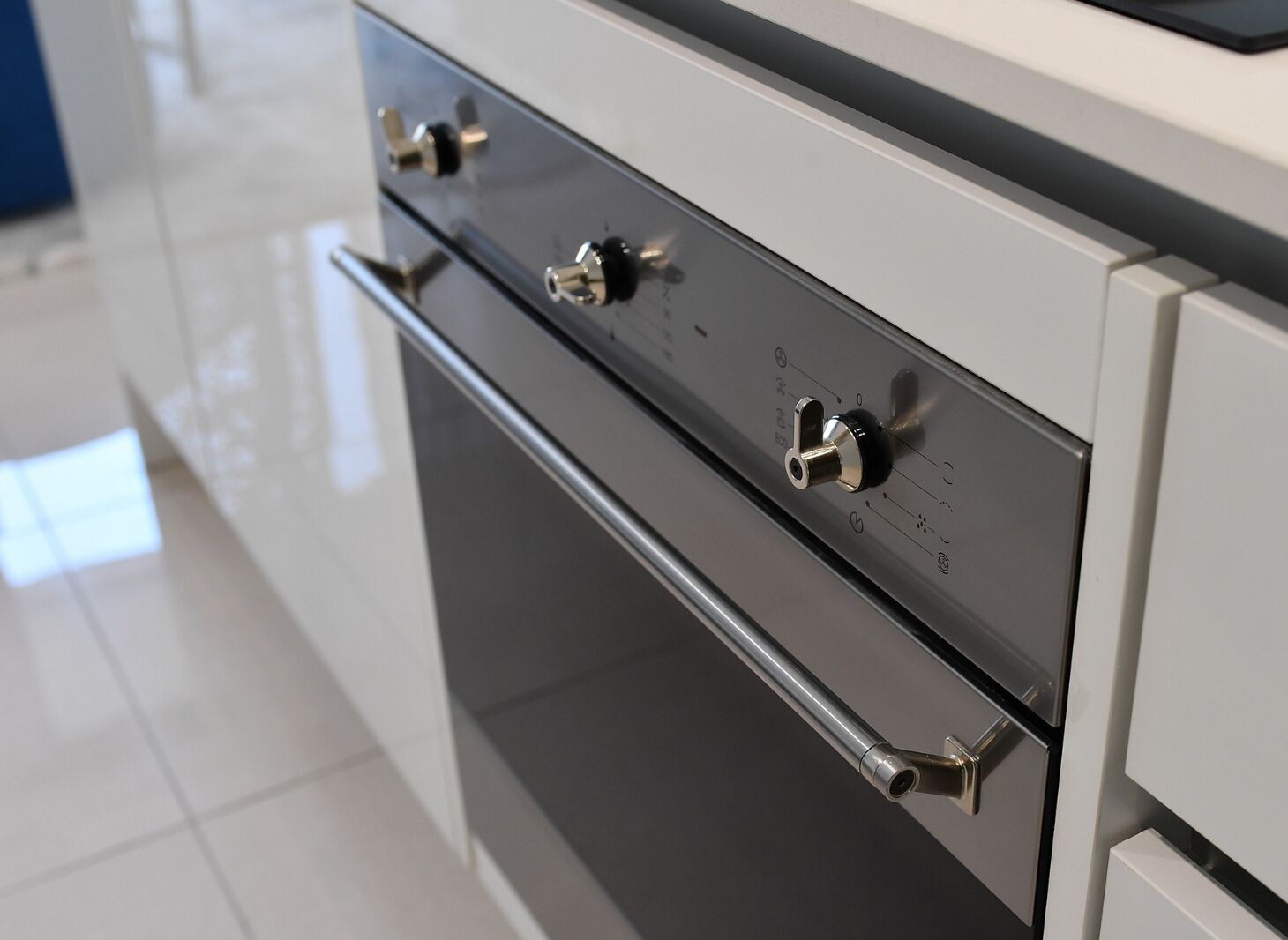 A kitchen with stainless steel appliances, including a stove and oven, and a white countertop.