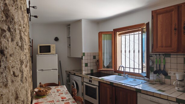 A compact kitchen with a microwave, oven, and sink. - An old oil press nestled between the sea and hiking trails (Santa-Reparata-Di-Balagna)