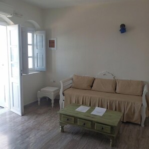 Superior Apartment Caldera View Private jetted Tub | Living area | 30-inch flat-screen TV with digital channels, TV - Captain John Traditional Houses - Adults Only (Santorini)