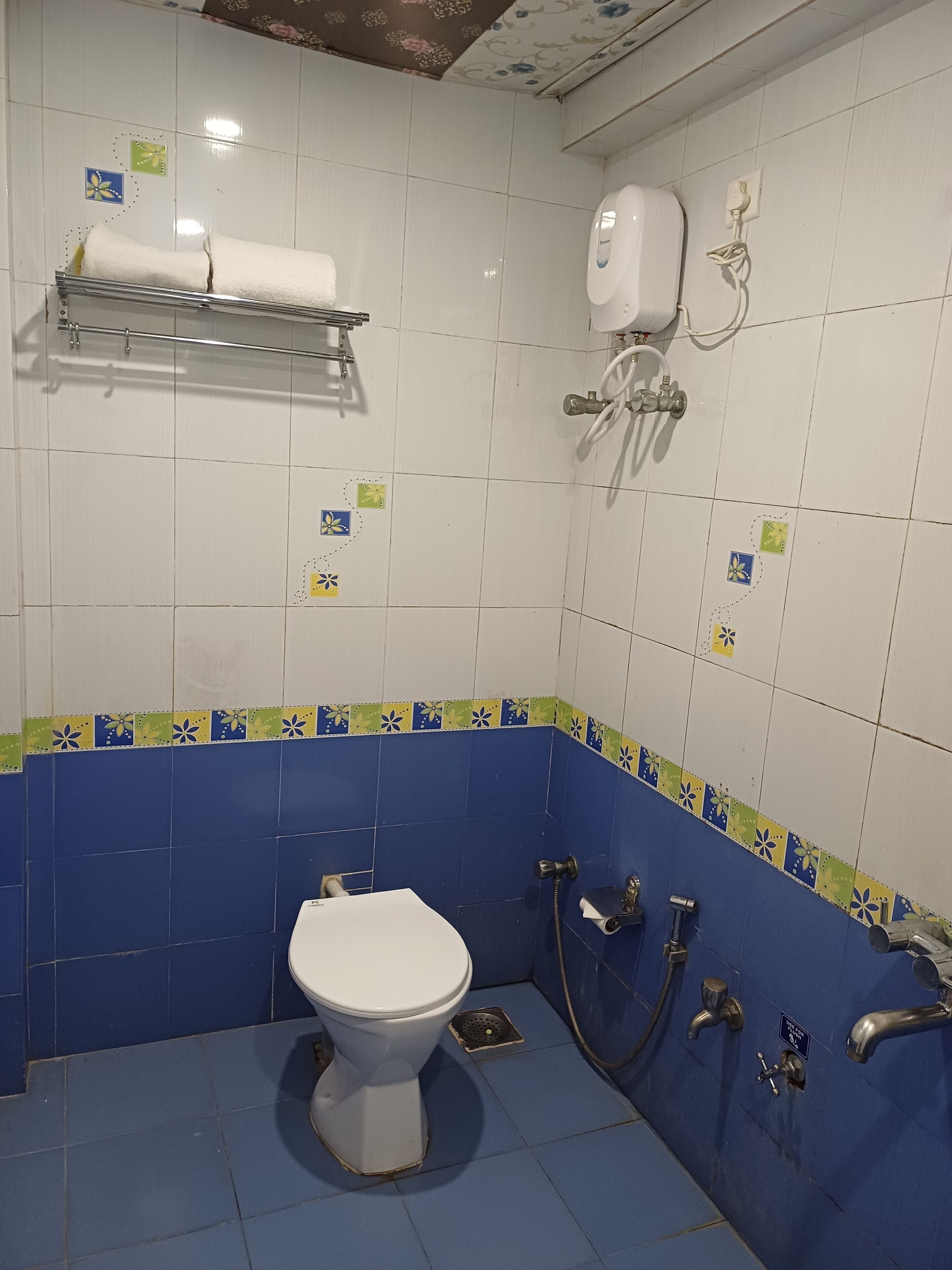 A bathroom with a toilet, a shower, and a sink.