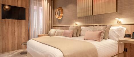A modern bedroom with a large bed, a mounted TV, and a wooden accent wall.