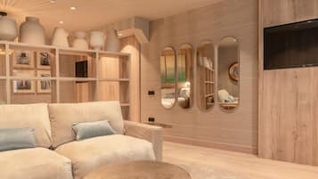 Una sala de estar moderna con un sofá color beige, una mesa de centro redonda y una pared de madera con estantes empotrados que exhiben objetos decorativos.