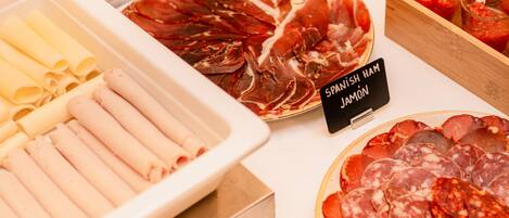 A variety of cured meats and cheeses on display.