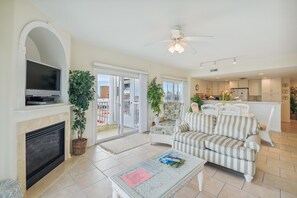 A living room with a television, sofa, and a fireplace. - XPLORIE ACTIVITIES & LINENS INCLUDED*! Great 3BR Condo Just a Short Walk to the Beach, Dining & Activities! (Ocean City)