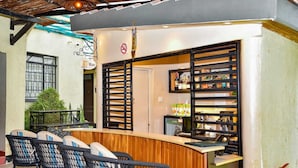 An outdoor bar area with a counter, seating, and a no beer sign. - Cozy Stead Hotel - Garden House, Gigiri (Nairobi)