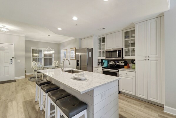Enjoy a functional workspace and casual dining area with a central island, sink, and bar stools.
