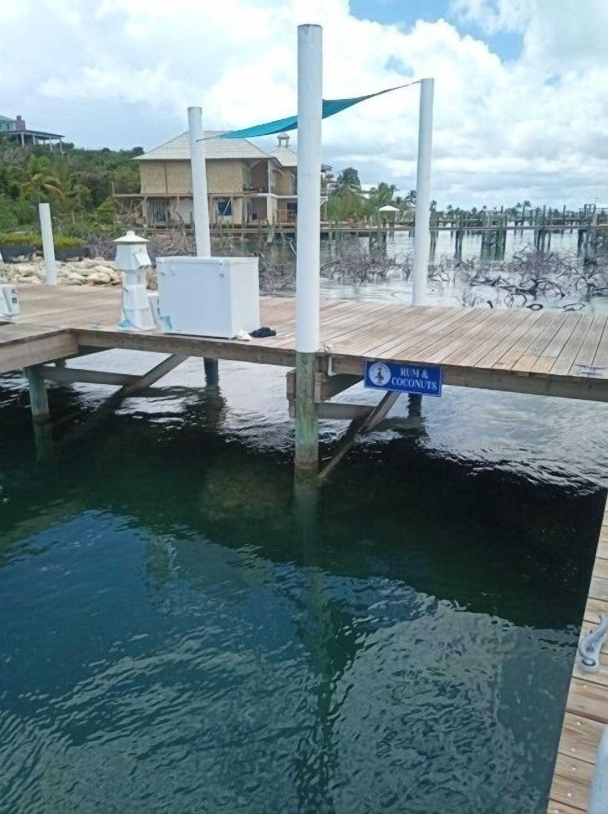 A dock with a sign reading "Rum & Coconut".