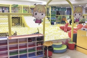 A children's play area with a ball pit, soft play structures, and storage shelves. - Liyuan Hot Spring Hotel (Fuyang)