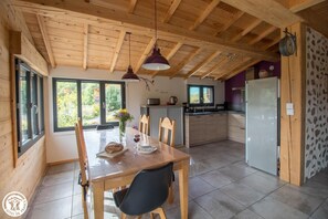 Enjoy meals in the dining area with a view of the surrounding greenery.