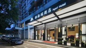 A hotel entrance with a modern design, featuring large glass doors and a red carpet leading to the lobby. - Hotel Jagri Taizhou (Taizhou)