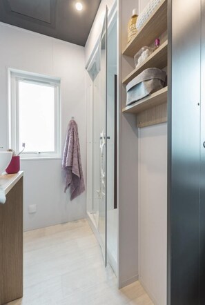 Bathroom features a large mirror, sink, and towel rack.