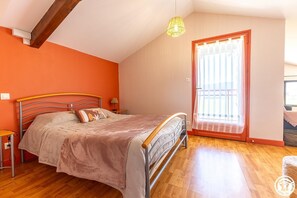 Cozy retreat with a single bed, sloped ceiling, and wooden beams.