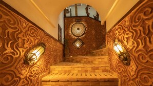 A staircase with ornate wall designs and patterned flooring, leading to a room labeled "ROOMS". - Riad Rihana Tamlalte (Ait Sedrate Jbel El Soufla)