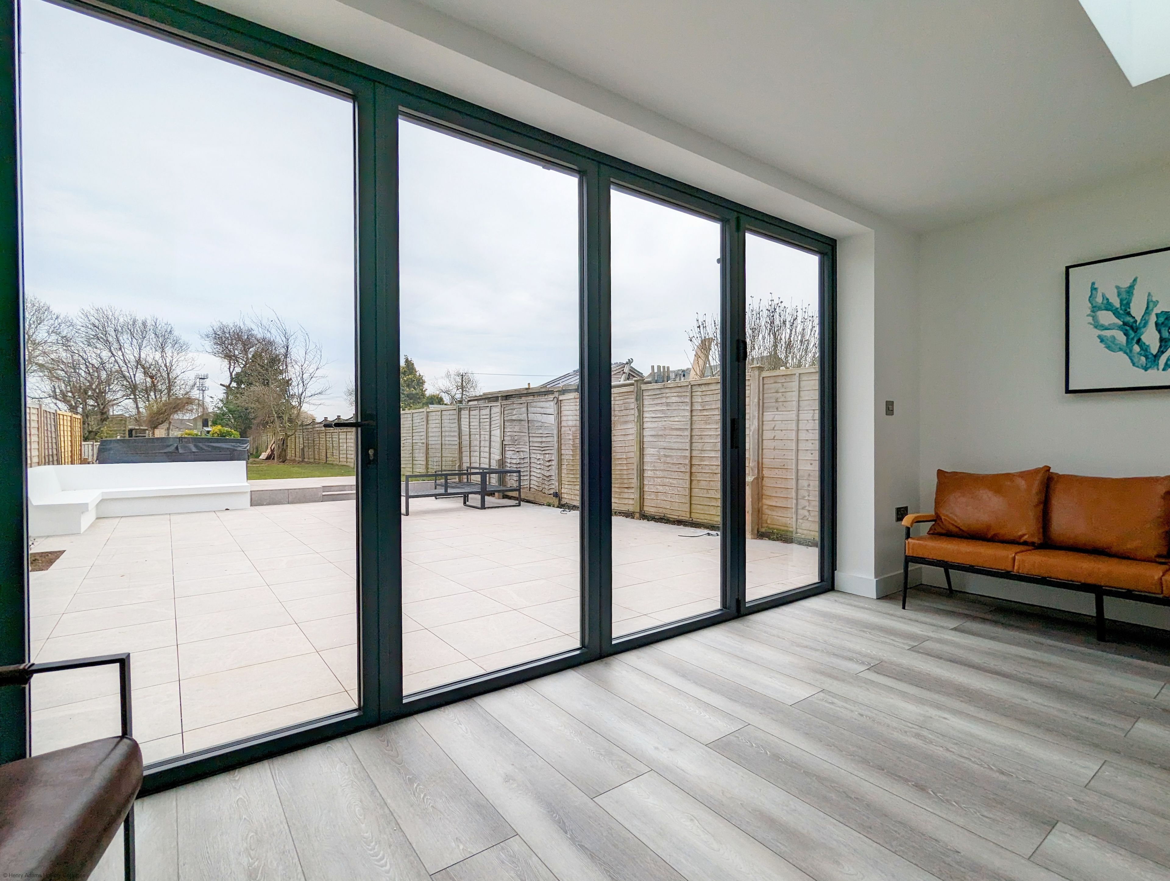 A spacious room with a large sliding glass door leading to an outdoor patio area.