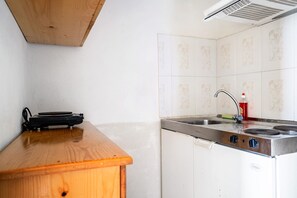 A kitchen with a wooden countertop, a sink, and a stove.