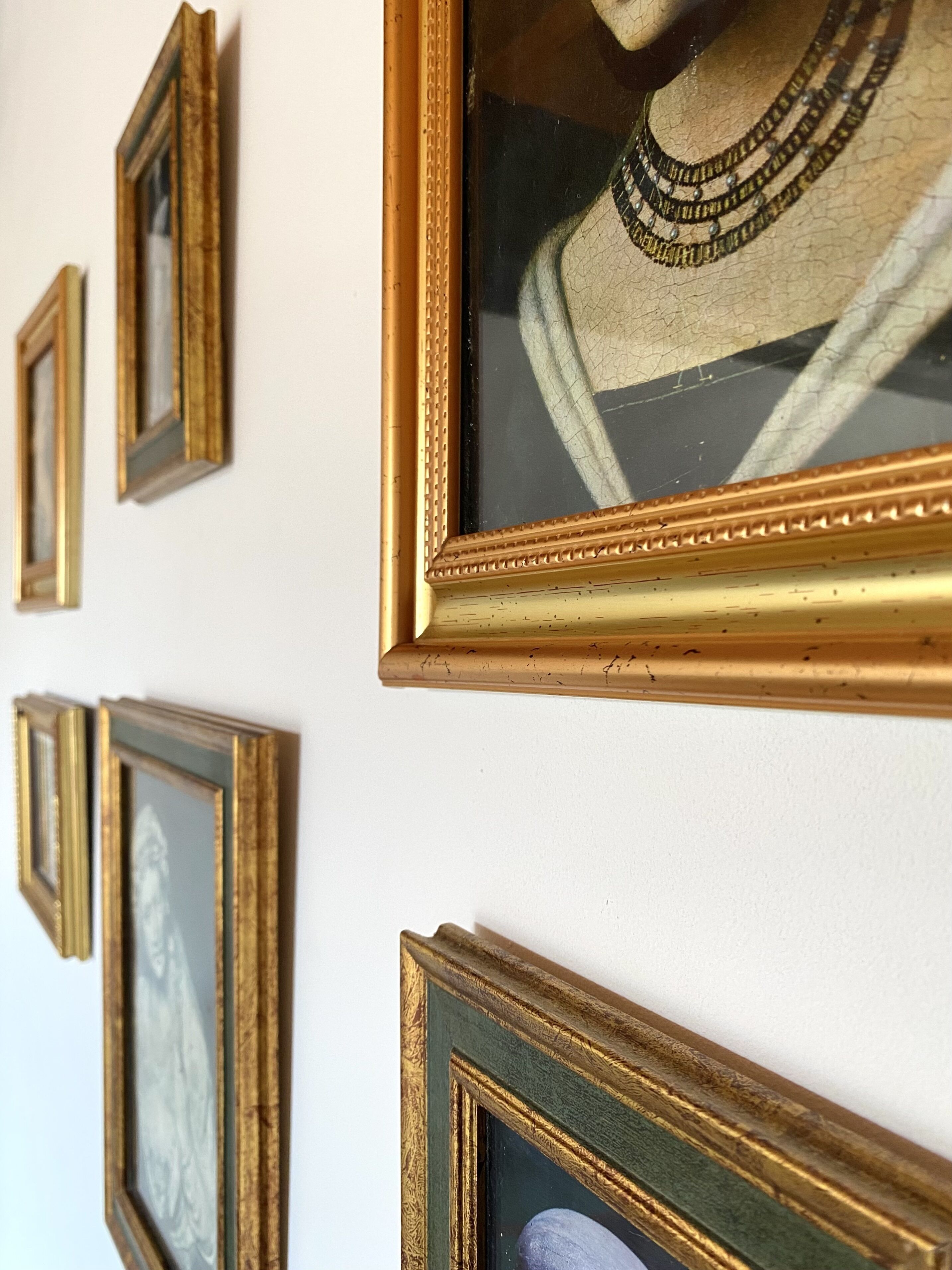 A wall with multiple framed pictures.
