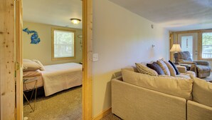 A room with a bed, a sofa, and a small table. - Relaxing Getaway with that UP North Feel! (Beaverton)