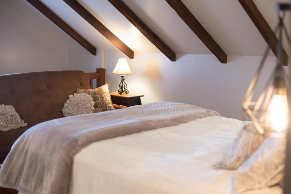 Futon at foot of bed in bedroom upstairs