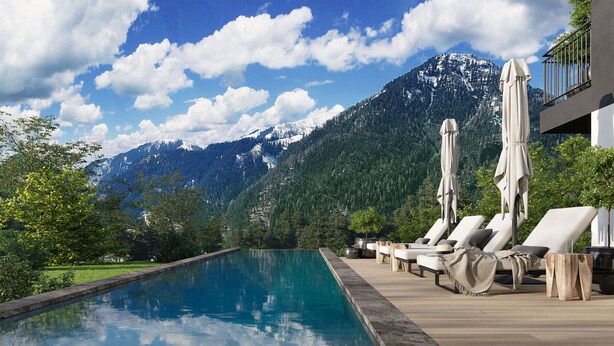 A poolside area with lounge chairs and umbrellas, a wooden deck, and a mountain backdrop. - Penthouse for up to 8 people & infinity pool (St. Martin am Tennengebirge)