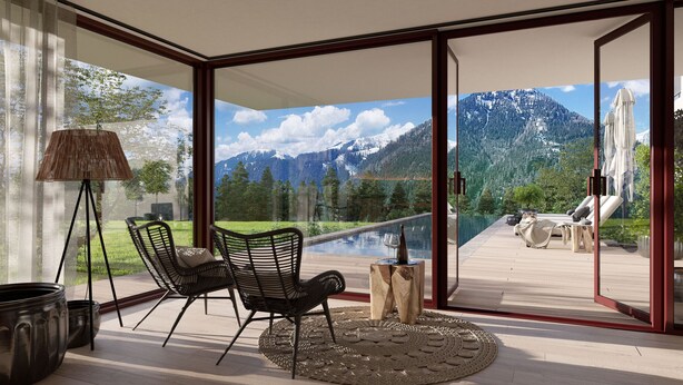 A modern outdoor seating area with a glass door leading to a mountain view.