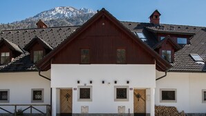 A traditional chalet-style building with a steeply pitched roof, wooden facade, and stone foundation. - Luxury gateway in Kranjska gora (Jesenice)