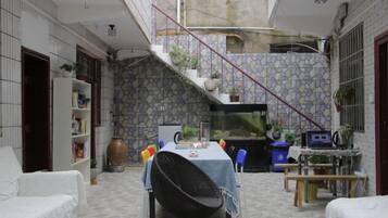 A dining area with a table, chairs, and a staircase leading to an upper level.