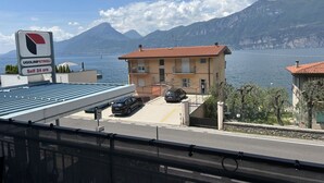 Un bâtiment avec un toit recouvert de tuiles rouges, un espace de stationnement et un panneau indiquant une station-service en libre-service.