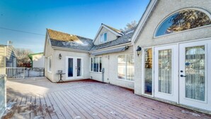 A two-story house with a wooden deck, large windows, and a garage. - First Place-Family Corporate Social Gatherings
Home Away From Home. Pet Friendly (Strathmore)