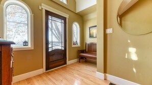 A spacious room with wooden flooring, a large window, and a bench. - First Place-Family Corporate Social Gatherings
Home Away From Home. Pet Friendly (Strathmore)