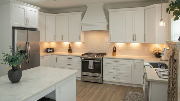 A modern kitchen with white cabinets, stainless steel appliances, and a central island. - "Lil House" Cozy 2-bedroom cottage walking distance to beach and downtown. (Bay St. Louis)