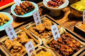 A variety of food items displayed in wooden trays with labels, likely in a restaurant or food market setting. - Palon Hotel (Chongqing Xinpaifang) (Chongqing)