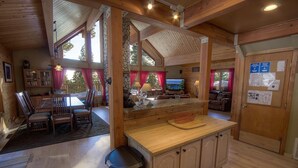 A cozy cabin interior with a dining area, kitchen, and living space. - The Bass Chalet 3 Bedroom Home by RedAwning (Kings Beach)
