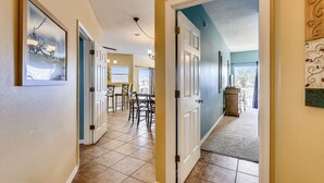 A hallway with a dining area, a kitchen, and a view of the outdoors. - SPC 9203 - Beautiful Upstairs 2 BR w/partial Gulf views and short walk to beach (Destin)
