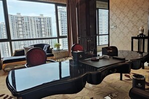 A modern office with a curved desk, leather chairs, and large windows offering a city view. - Lotin Hot Springs Hotel (Gaozhou)