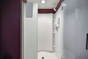 A modern bathroom with a glass shower enclosure, a white sink, and a mirror. - Home2 Suites By Hilton Livermore (Livermore)