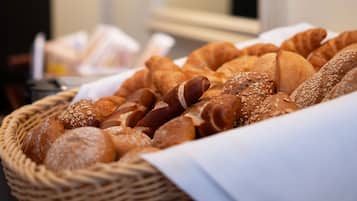 A basket of various breads and pastries.