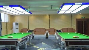 A pool table with two chairs, a ceiling light fixture, and a wall-mounted air conditioning unit. - Captain Chain Hotel (Daixian Selected) (Dai County)