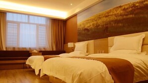 A hotel room with a large bed, a nightstand, a lamp, and a painting on the wall. - Captain Chain Hotel (Daixian Selected) (Dai County)