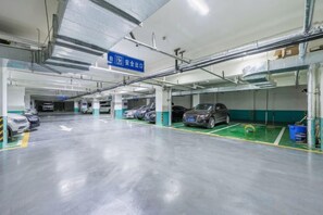 A multi-level parking garage with clear directional signage, multiple parking spaces, and a clean, well-maintained floor. - Ann Keats Hotel (Lanzhou)