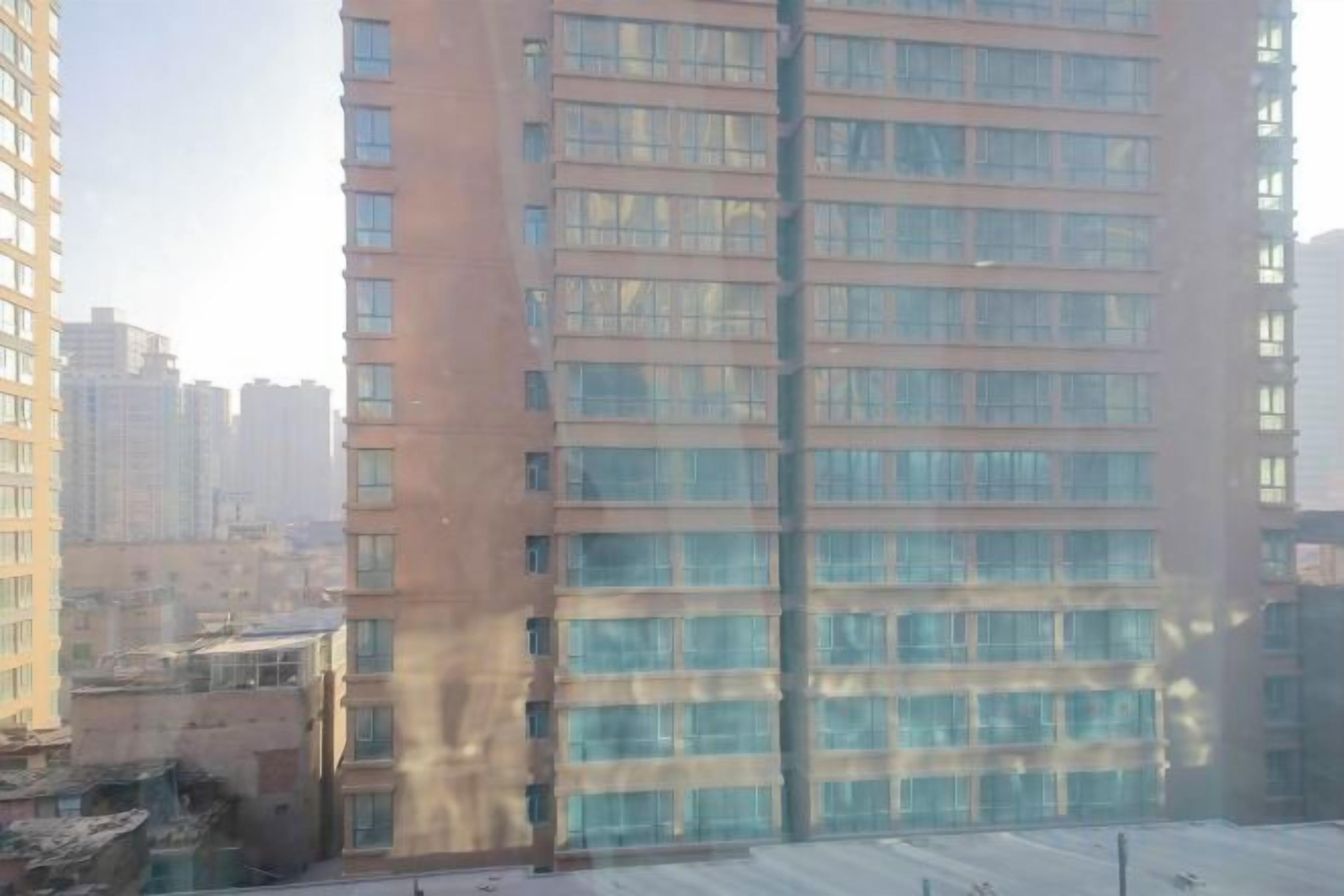 A high-rise building with multiple floors and a clear view of the surrounding urban area.