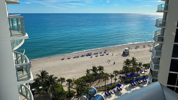 A beachfront hotel with a view of the ocean, a sandy beach, and palm trees. - Marenas Beach Resort (Sunny Isles Beach)