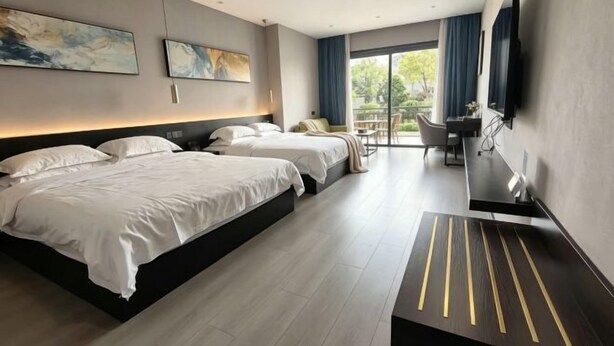 A modern hotel room with two beds, a desk, and a large window.