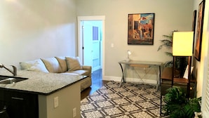 A modern kitchen with granite countertops, a built-in sink, and a ceiling fan. - RVA Arts District near VCU MCV (Richmond)