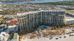 Un hôtel à plusieurs étages doté d’une piscine et d’un accès à la plage.