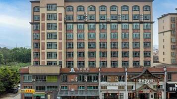 A multi-story hotel with a prominent sign at the top.
